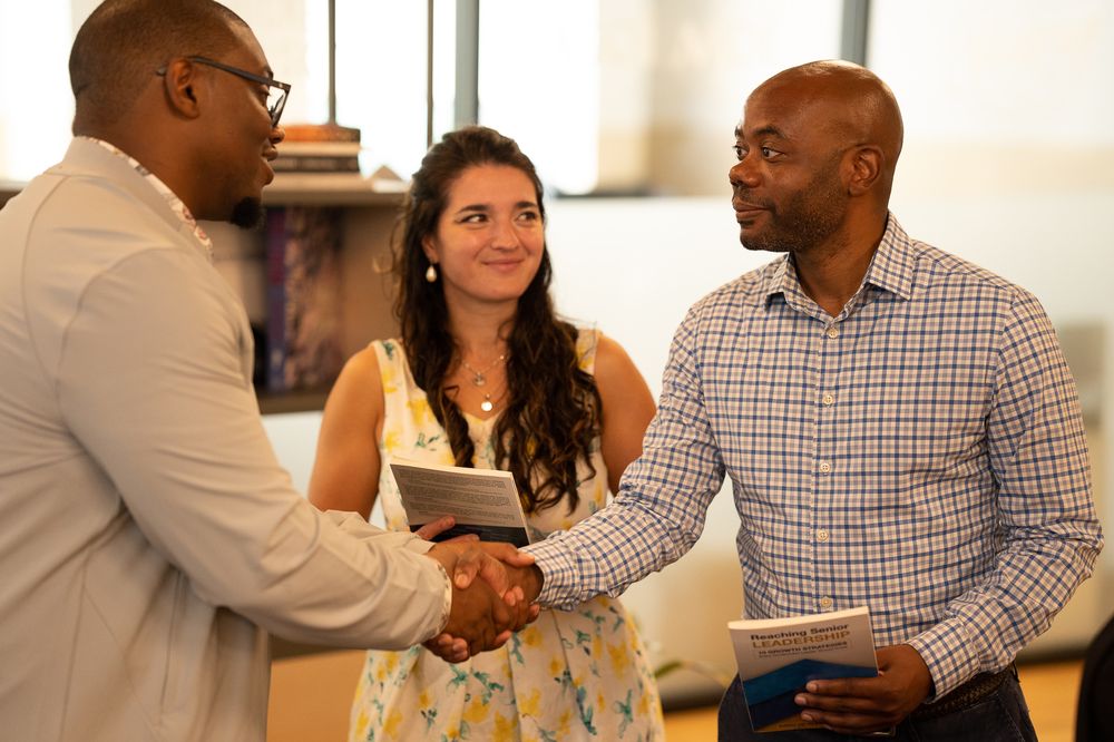 Alex D. Tremble meeting attendees after a session